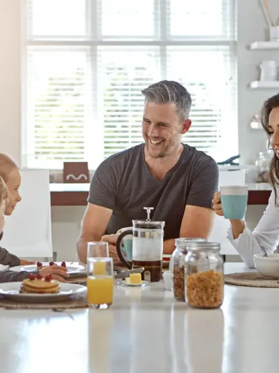 gezin met twee kinderen aan tafel 